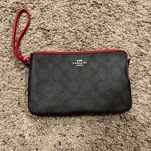 Coach double zip wallet in signature canvas.